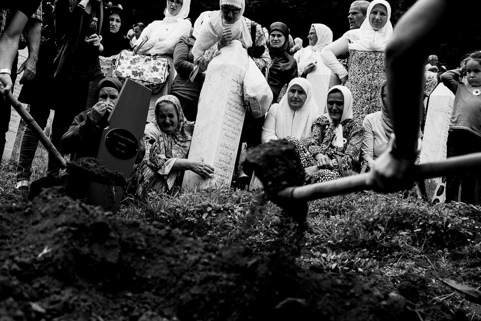 Muslim Bosnians burying the bodies of newly identified victims of genocide at the Srebrenica Potočari Memorial site.