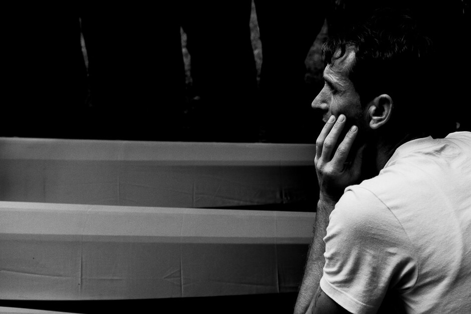 A man mourning next to the coffins of victims to be buried at the Srebrenica Potočari Memorial site.
