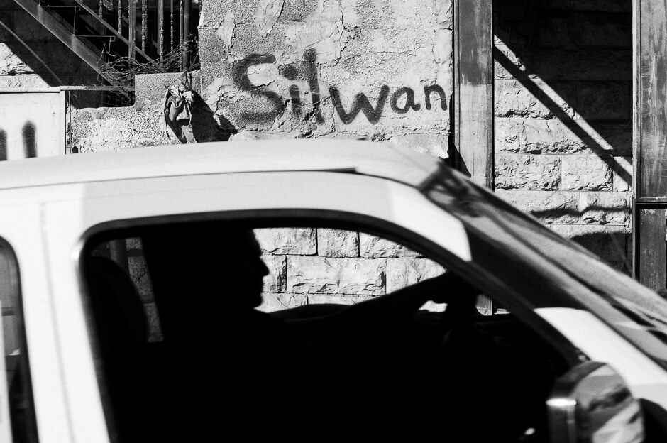 Car driving through Silwan in East Jerusalem .