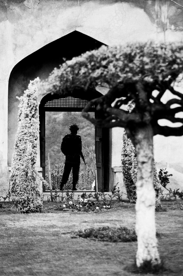 Indian soldier in a mughal garden overlooking Srinagar, the summer capital of Kashmir.