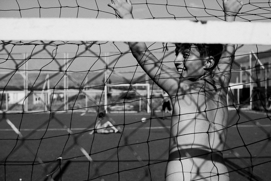 Boys on the schools football pitch at the Tserovani refugee camp.