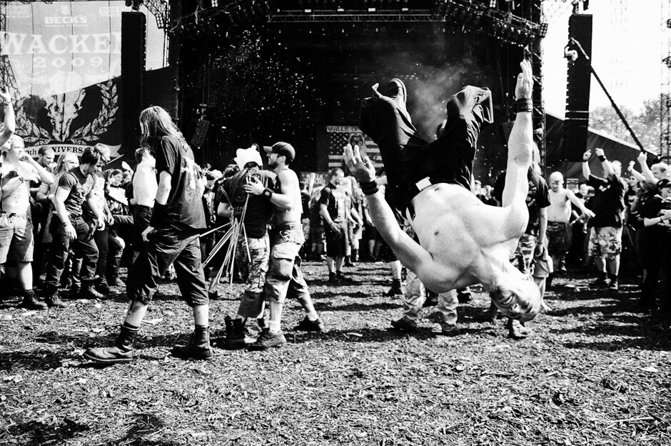 Mosh Pit at Walls of Jericho - Wacken Open Air 2009 Metal fan making a backflip in the mosh pit during the set of Walls of Jericho at Wacken Open Air 2009.