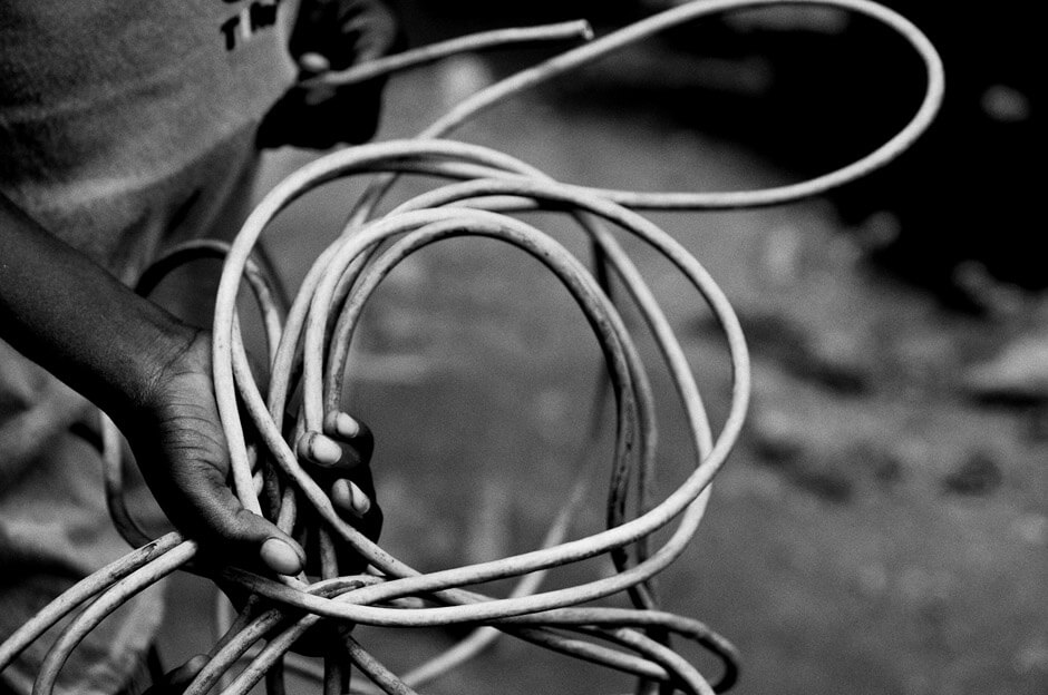 Boy holding a cable from electronic trash in the neighbourhood of Agbogbloshie in Ghanas capital Accra, better known by the locals as Sodom & Gomorrah.