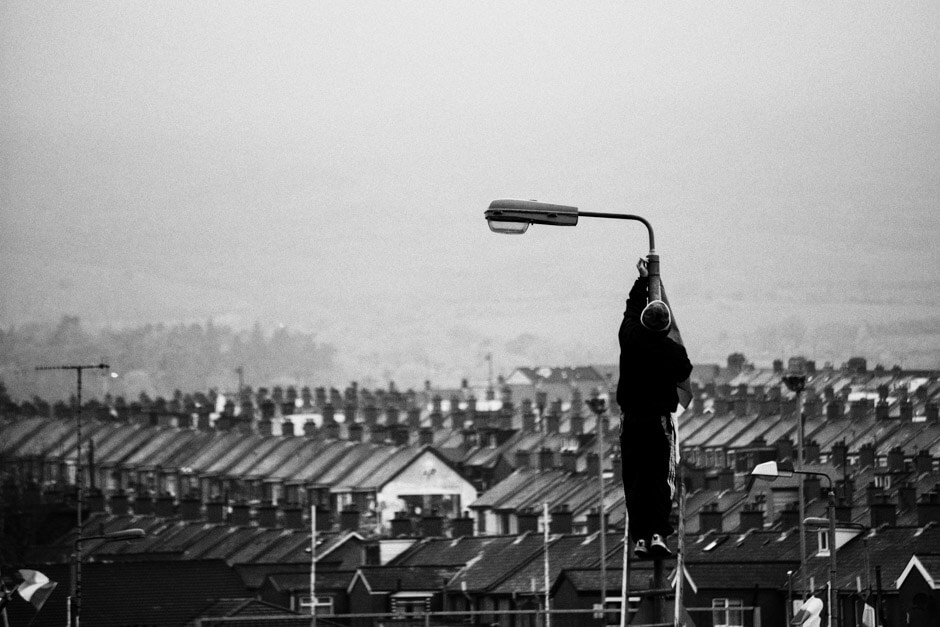 Irish national flag being hoisted over Ardoyne/Belfast for easter rising commemorations.