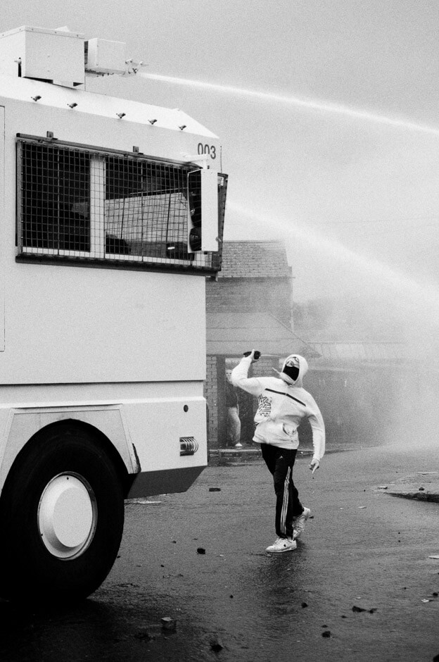 Nationalist rioter stoning a PSNI water canon on the 12th of July in Ardoyne/Belfast.