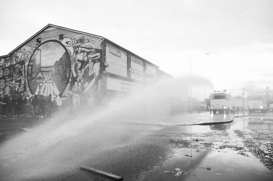 Nationalist protesters hiding from PSNI water canon during riots on the 12th of July in Ardoyne/Belfast.