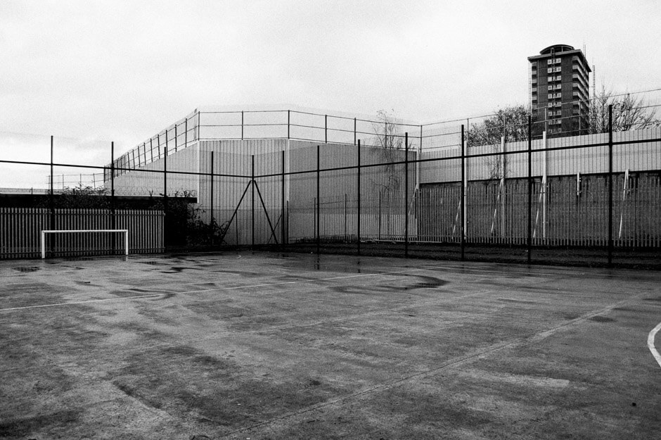 Football pitch at peaceline operating Loyalist lower Shankill from Nationalist Falls Road.