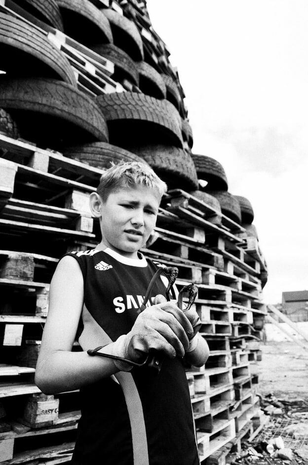 Young Loyalist in front of Lanark Way bonfire in the Shankill area of Belfast.