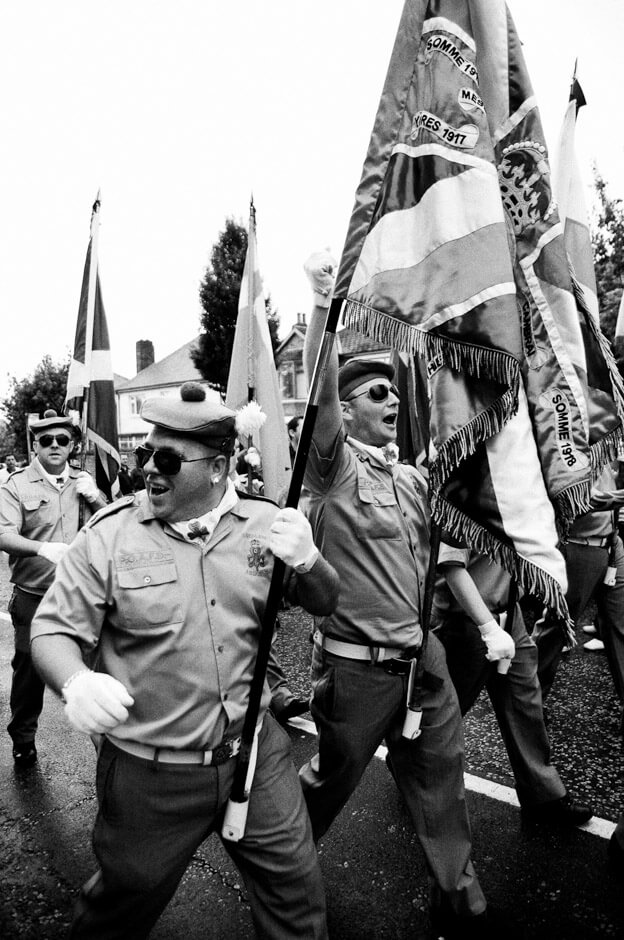 Loyalist bandsman of the Pride of Ardoyne triumphantly marching past Ardoyne shops on the 12th of July.